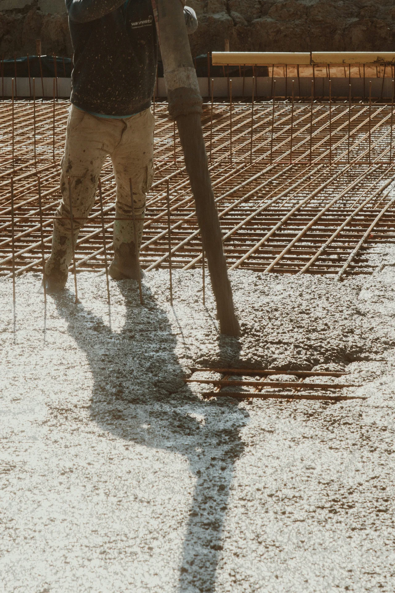 concrete pump hose placing concrete over a Regina rebar mat