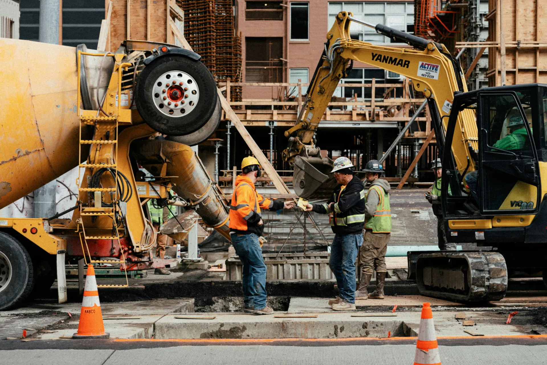 ready mix concrete pour on a Regina urban site with a mini excavator