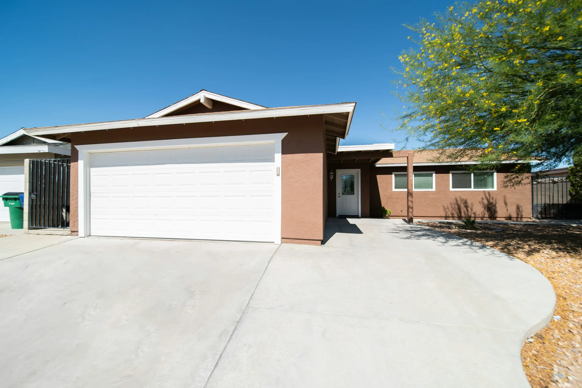 broom-finish concrete driveway at a Regina stucco home