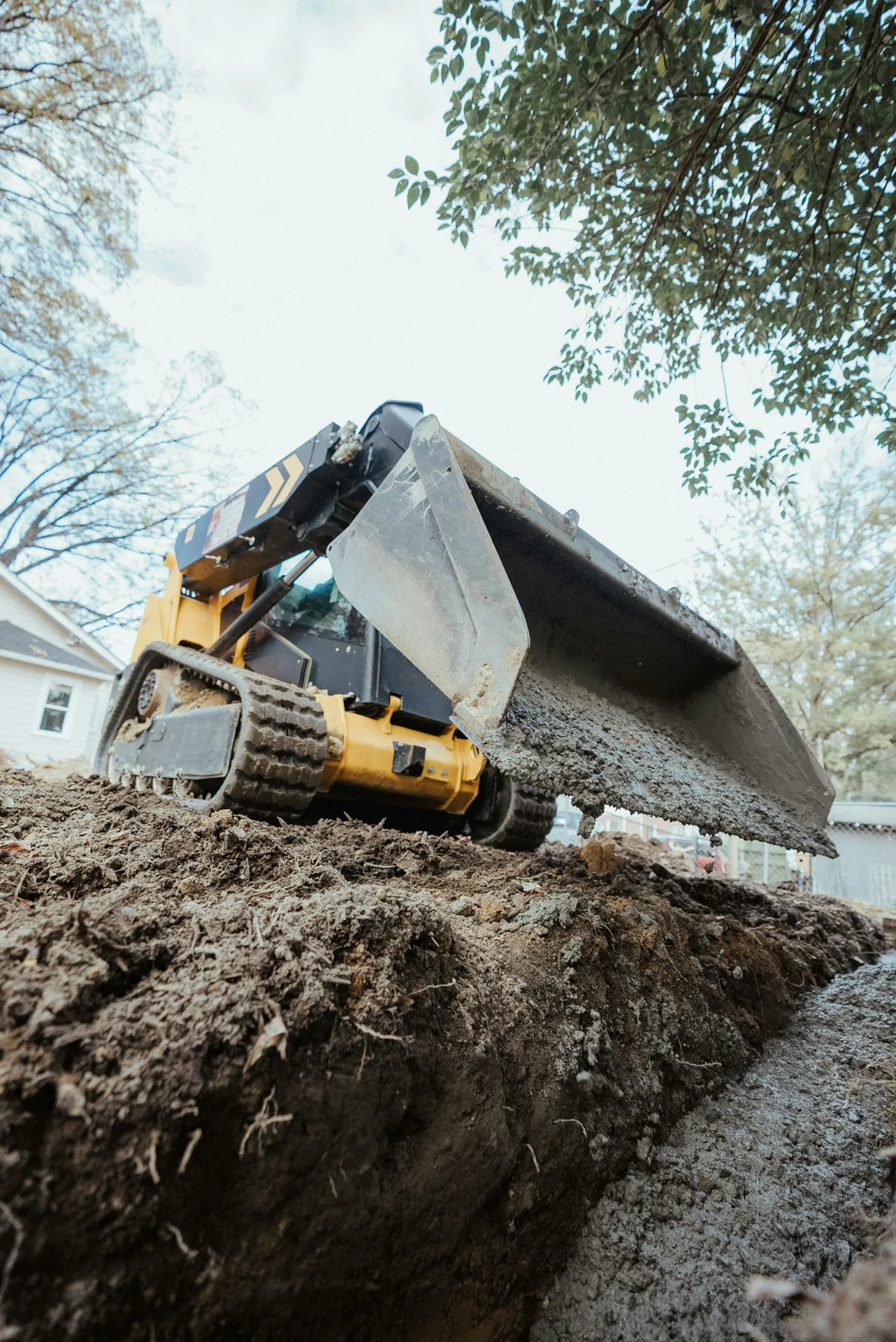foundation repair pour with a track loader in Regina