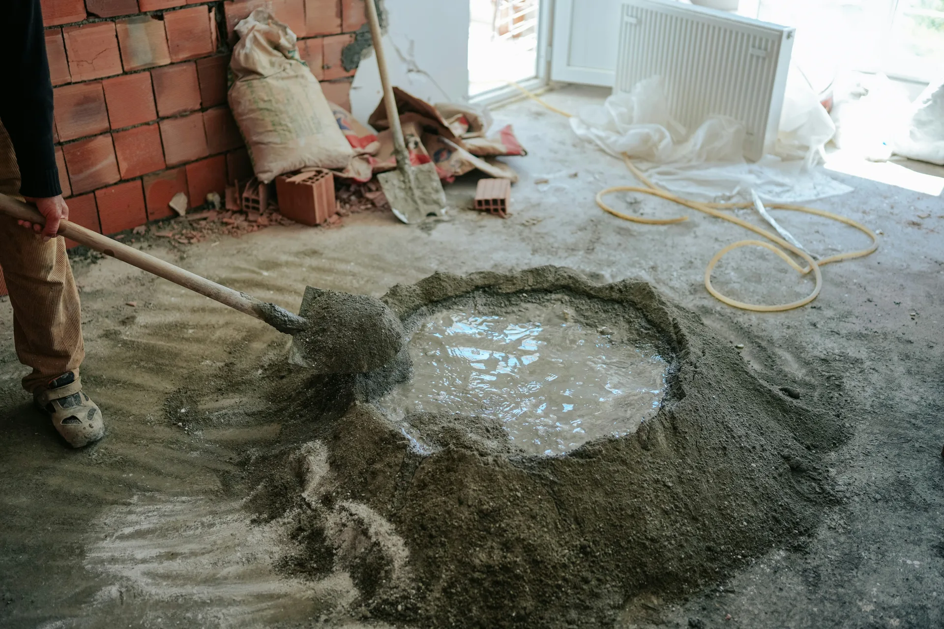 Mapei self-leveling compound being mixed on a Regina renovation site