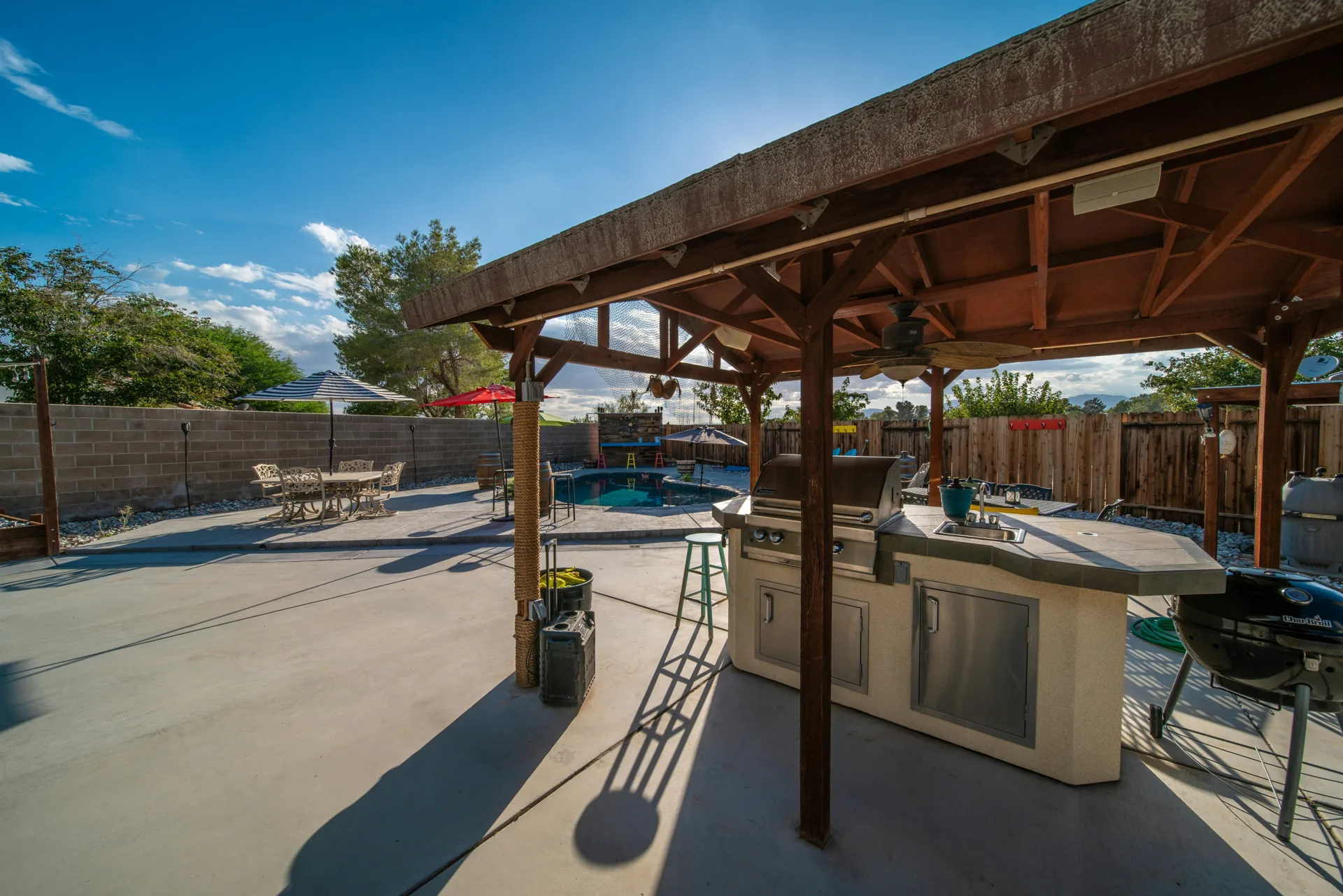 broom-finish concrete pad around a fire pit at a Regina home