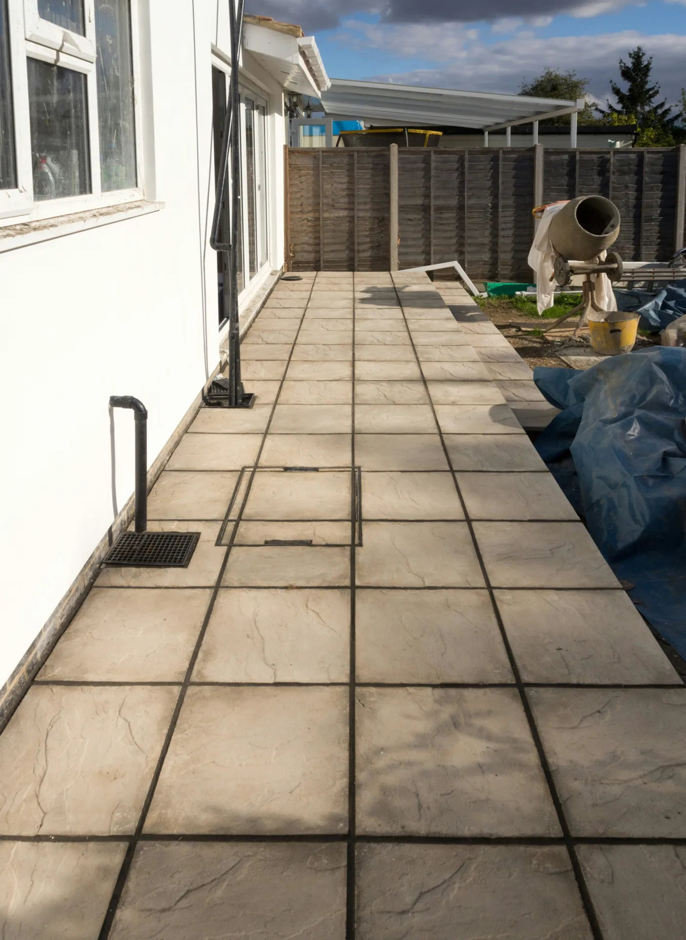 concrete walkway installation along the side yard of a Regina home